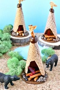 three small model tents with animals in front of them