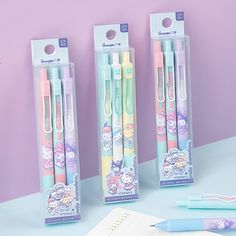 three hello kitty pens are in their packaging next to a notepad and pencils