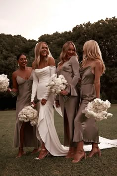 bridesmaids pose for a photo with their bouquets