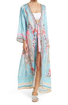 Unleash your free boho spirit in this longline v-neck kimono styled with vivid patterns and front tie closure. V-neck Open front with tie closure Kimono sleeves All-over print Woven 100% polyester silk Hand wash cold, line dry Imported Model stats: 5'10", 32" bust, 25" waist, 36" hip. Model is wearing one size. Bohemian V-neck Kaftan For Spring, Flowy Bohemian V-neck Kimono, V-neck Floral Print Festival Cover-up, Bohemian Tie Waist Cover-up For Beach Season, Casual V-neck Kimono With Boho Print, V-neck Printed Kimono For Festivals, Bohemian V-neck Tie Waist Cover-up, Bohemian V-neck Cover-up With Floral Print, Bohemian V-neck Floral Print Cover-up