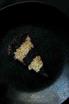 a piece of cake sitting on top of a black plate