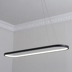 a black and white light hanging from a ceiling