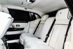 the interior of a luxury car with white leather seats and black trimmings on it