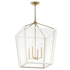 a large clear glass lantern hanging from the ceiling with gold trimmings and four candles