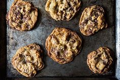 chocolate chip cookies on a baking sheet ready to be baked in the oven for consumption