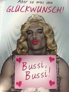 a woman with blonde hair holding a sign that says busi, busti and kisses