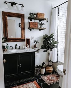 the bathroom is decorated in black and white