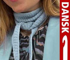 a close up of a woman wearing a scarf and jacket with the words dawsk on it