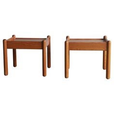 two wooden stools sitting next to each other