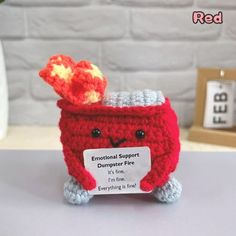 Adorable Crochet Dumpster Fire: Handmade with love, this adorable crochet dumpster fire doll is the perfect gift for anyone looking to add a of whimsy and humor to their desk decor. Its cute and unique design is sure to catch everyone's attention. Emotional Support Dumpster Fire: This handcrafted emotional support dumpster fire toy offers a lighthearted way to cope with challenges. Whether you need a little pick-me-up or want to bring a smile to someone's face, this plush doll is there to provide comfort and support. High-Quality Craftsmanship: Made with attention to detail, our crochet dumpster fire is crafted with high-quality materials to ensure durability and long-lasting enjoyment. Each stitch is carefully woven to create a visually appealing and well-made product. Fun Desk Accessorie Desk Decor Christmas, Crochet Christmas Decor, Cool Desk Accessories, Crochet Stuffies, Fun Desk, Knitting Toy, Buddy Gifts, Spreading Positivity, Unique Christmas Ornaments