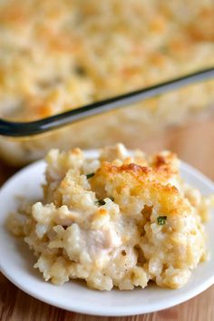 a white plate topped with mashed potatoes next to a casserole dish