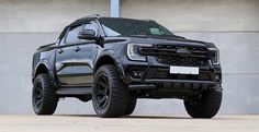 a black truck parked in front of a building