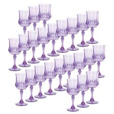 a set of twelve purple wine goblets sitting next to each other on a white background