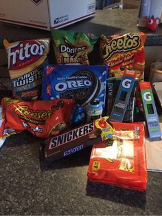 a counter top filled with lots of different types of snacks and candy bar wrappers