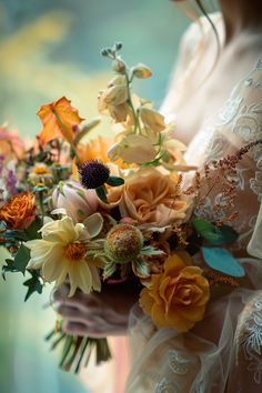 a woman holding a bouquet of flowers in her hands