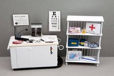 two white shelves with medical supplies on them and a red cross sign in the middle