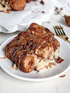 a piece of bread with caramel drizzled on it sitting on a white plate