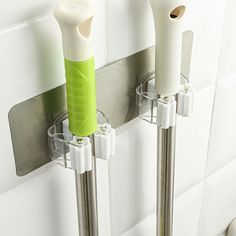 two toothbrush holders are attached to the wall