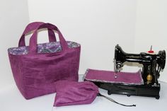 a sewing machine and bag sitting next to each other on a white surface with a wall in the background