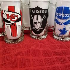 four glasses with different nfl logos on them