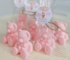 small pink teddy bears sitting on top of a white plate with thank you tags attached to them