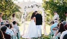 a bride and groom are standing under an arch at the end of their wedding ceremony