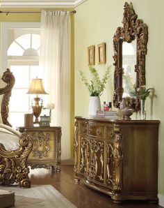 a bedroom with yellow walls and gold furniture