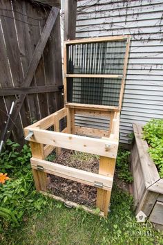 a chicken coop built into the side of a house with plants growing out of it