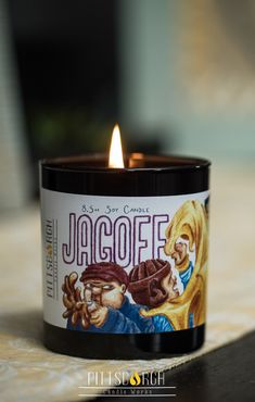 a candle that is sitting on top of a table with the words jagoffe printed on it