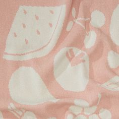 a pink and white fabric with fruit on it