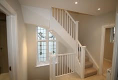 an empty room with stairs leading to the second floor