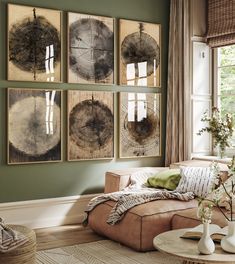 a living room filled with furniture and paintings on the wall above it's coffee table