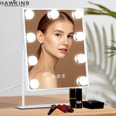 a woman's face is shown in front of a mirror with lights on it