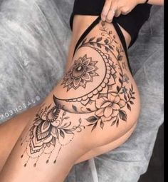 a woman's thigh with tattoos on it