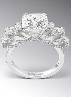 a diamond ring with an intricate design on the band and center stone in the middle