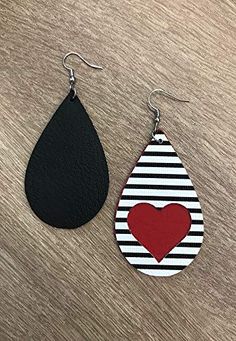 two pairs of leather earrings with a heart painted on the front and black, white, and red tear