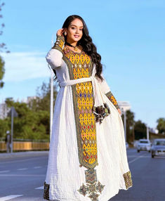 Step into regal elegance with our Golden Yellow Axum Fetil Ethiopian Dress, a breathtaking masterpiece that marries tradition with opulence. This Habesha Kemis boasts a radiant golden yellow hue, reminiscent of the majestic sunsets over Axum. Adorned with intricate detailing, this Ethiopian dress exudes grace and sophistication, capturing the essence of timeless beauty. Habesha Dress Modern, Habesha Dress, Ethiopian Traditional Dress, Ethiopian Dress, Habesha Kemis, Regal Elegance, Dress Modern, Cultural Celebration, Modern Dress