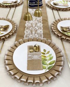 a table set with place settings, plates and napkins