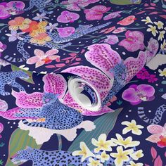 a blue and pink floral print fabric with lots of flowers on the bottom half of it