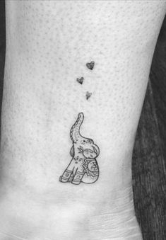 an elephant with hearts flying out of it's trunk on the side of the foot