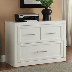 a white dresser with two drawers and a printer on top