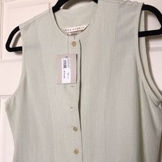 Max Studio Sleeveless Partially Buttoned Down Top In A Small Pale Green Check Print. Small “Aged” Mark On The Bottom Front (See Photo) From Being In Closet/Time Nwt Never Worn Classic Shirt Short In Length. Not Cropped, But Not Long. Classic Stretch Vest For Spring, Classic Spring Vest, Classic Sleeveless Blouse Tank Top For Spring, Classic Sleeveless Tank Top For Spring, Classic Sleeveless Vest For Daywear, Classic Sleeveless Tank Top For Summer, Classic Sleeveless Tops For Spring, Classic Sleeveless Top For Daywear, Classic Sleeveless Summer Vest