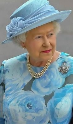 the queen of england is wearing a blue hat