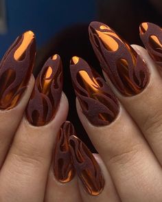 Fiery Flames nails are perfect for those who love bold and dramatic designs. This manicure features a metallic copper base with black flame accents, creating a striking and edgy look that’s sure to turn heads.   Photo credit by: @riri.nailz Copper Nails Designs, Fall Nail Art Ideas, Copper Nails, Chrome Nails Designs, Graduation Nails, Fall Nail Trends, Fall Nail Art Designs, Geometric Nail, Fall Nail Art