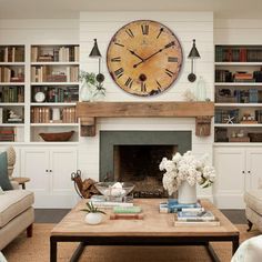 a living room filled with furniture and a large clock mounted to the wall above it