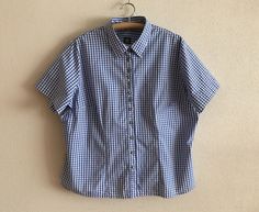 "Blue Gingham Shirt Plaid Dirndl Blouse Checkered Trachten Shirt Blue White Plaid Blouse Short Sleeve Cotton Top Plus Size Extra Large   Label size: 54/56 EUR, 28 UK Measurements (lying flat): Length: 27.5\"/ 70 cm Shoulder: 19\"/ 48 cm Pit to pit: 28\"/ 71 cm Sleeve: 9.5\"/ 24 cm Please check measurements to insure a proper fit. Remember to allow yourself some extra room for movement. You can compare these with something from your closet that fits you well. Condition: Great Vintage Condition Material: 100%cotton N.B. Color may slightly differ from picture SHIPPING * I ship worldwide via Priority mail * Items are shipped 1 - 3 business days after receiving the payment. * I ship from Europe, so please allow 2 to 4 weeks for the package to arrive if you live overseas. * Europe 5 - 10 busines Gingham Button Up Shirt Outfit, Classic Fitted Gingham Blouse, Short Sleeve Gingham Blouse For Work, Short Sleeve Gingham Shirt For Work, Gingham Short Sleeve Blouse For Work, Gingham Short Sleeve Shirt For Workwear, Gingham Short Sleeve Shirt For Work, Patterned Button Up, Gingham Shirt Outfit