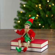 a small elf sitting on top of a book