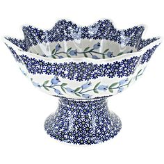 a blue and white flowered bowl on a white background with flowers in the center