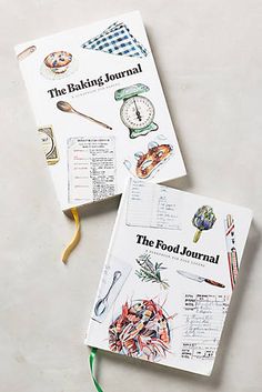 two cookbooks sitting next to each other on top of a white table with green ribbon