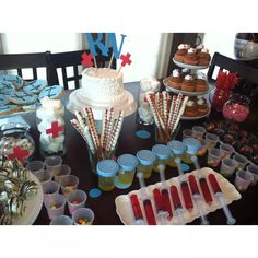 a table topped with lots of cupcakes and desserts